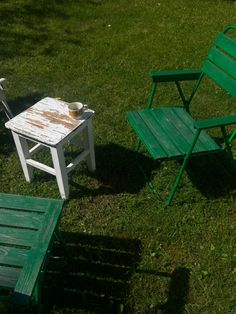 two chairs and a table in the grass