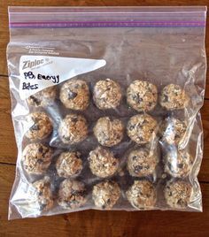 a bag filled with lots of oatmeal balls on top of a wooden table