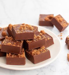 a white plate topped with pieces of chocolate