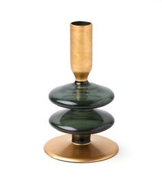 a gold and green vase sitting on top of a metal stand with a black base