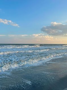 the ocean waves are rolling in to shore