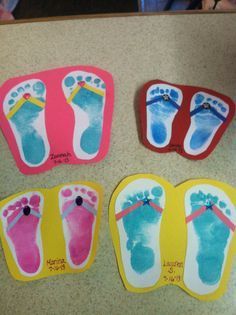 four pairs of feet are painted in different colors and sizes on the counter top,