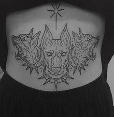 a woman's lower back with three wolfs on the side and stars above her