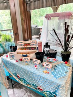 there are many items on the table that is set up for an outdoor event or party