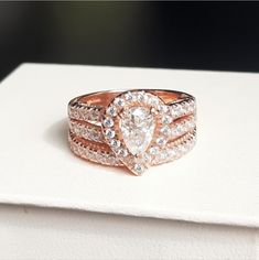 a close up of a ring on top of a white box with diamonds in it