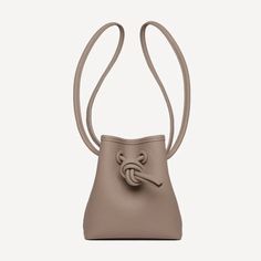 6.30”W X 7.1”H X 3.9”D Brand New Versatile Brown Bucket Bag For Evening, Chic Taupe Leather Bucket Bag, Chic Light Brown Leather Bucket Bag, Elegant Light Brown Bucket Bag, Brown Textured Leather Bucket Bag For Evening, Brown Textured Leather Evening Bucket Bag, Mini Mini, Tan Brown, Wristlets