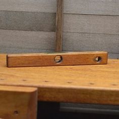 a close up of a wooden table with a piece of wood sticking out of it