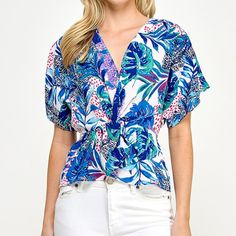 Blue Tropical Short Sleeve Dolman V-neck Top With Tropical Print For Brunch, Spring Beach Blouse In Blue, Spring Beach Blue Blouse, Spring Blue Blouse For Beach, Spring Blue Printed Tops, Blue Short Sleeve Blouse For Vacation, Blue Printed Tops For Spring, Blue V-neck Blouse For Day Out, Summer Tropical Print Blue Blouse