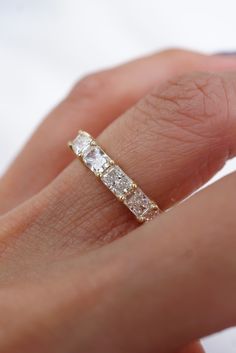 a woman's hand with a diamond ring on it