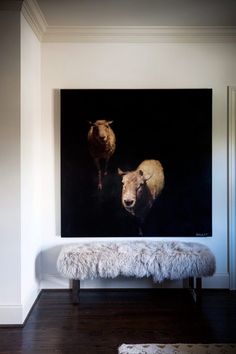 an animal painting on the wall above a bench