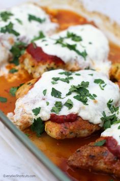 some meat covered in sauce and garnished with parsley