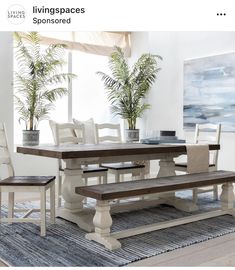 a dining room table with two benches in front of it