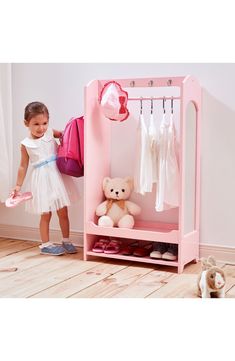 This toy clothing rack with white polka dots is a fun and functional addition to your child's bedroom or play area. It has a hanging area, seven storage hooks for accessories and two lower shelves for shoes and toys to keep your little one organized. Warning: Choking hazard. Small parts. Not for children under 3 years Ages 3 and up 31.38" x 10.38" x 40.25" 36 lb. Assembly required MDF Wipe clean Imported Dress Up Room For Toddlers, Kid Clothing Shelves, Travel Dress Up Closet For Kids, Children's Dress Up Storage, Toddler Dress Up Hooks, Princess Dress Up Rack, Toddler Dress Up Station Ikea, Childrens Dress Up Storage, No Closet Toddler Room