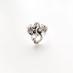 I make this ring using an antique silver dragon charm and an adjustable ring base.  This ring will arrive safely in a gift box.More Dragon Jewelry:https://www.etsy.com/shop/lydiasvintage?ref=l2-shopheader-name&search_query=dragon More Rings:https://www.etsy.com/shop/lydiasvintage?ref=l2-shopheader-name&section_id=6786660Bridesmaids Quantities:https://www.etsy.com/shop/lydiasvintage?ref=l2-shopheader-name&section_id=7069689If you need more jewelry, please let me know- I have bracelets Dragon Ring, Dragon Lover, Dragon Jewelry, Silver Dragon, Steampunk Jewelry, Fantasy Dragon, Adjustable Ring, Accessories For Women, Adjustable Rings