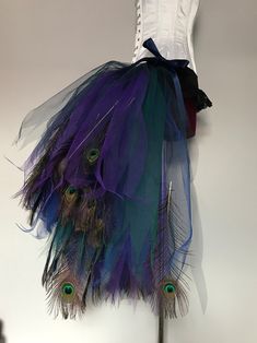 a dress with peacock feathers hanging on the wall