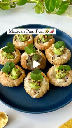 a blue plate topped with mini appetizers covered in guacamole and cilantro