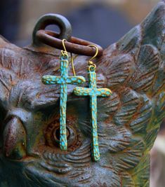 Rustic hammered brass crosses, washed with a turquoise patina, sway long & lovely from simple brass ear wires...So Bohemian Chic! Uniquely hand crafted with these quality materials: ~ Hammered brass cross charms with turquoise patina, washed with non-toxic acrylic paint & sealed with Renaissance Wax ~ Antiqued brass lead & nickel-free French style ear wires ~ Silicone earring backs to keep earrings securely in ears Measuring 2-1/4 inches from the top of the ear wires to the bottom of Bohemian Cross Jewelry For Festival, Bohemian Cross Shaped Brass Jewelry, Bohemian Brass Cross Jewelry, Bohemian Turquoise Hammered Earrings, Bohemian Style Brass Cross Jewelry, Bohemian Blue Hammered Earrings, Blue Bohemian Hammered Earrings, Hippie Chic Jewelry, In Ears