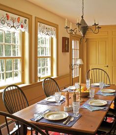 the dining room table is set with place settings