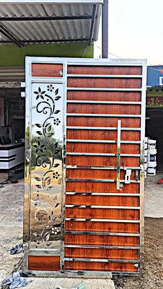 a metal door with wooden slats in front of a building that is under construction