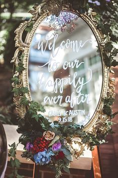 a mirror that has some flowers in it and the words welcome to our happily ever after written on it