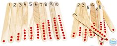 several wooden matches with numbers on them and one has red dots in the top row