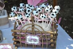 a table topped with marshmallows and cake pops covered in cow's milk