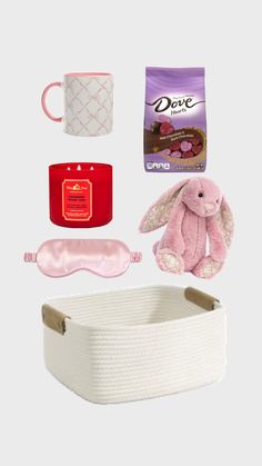 an assortment of items that include a pink bunny, coffee mug, eye mask and other items