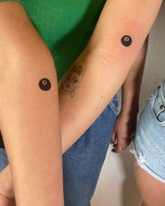 two people with matching tattoos on their arms