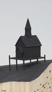 a wooden church on top of a hill