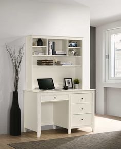 a white desk with a laptop computer on top of it next to a book shelf