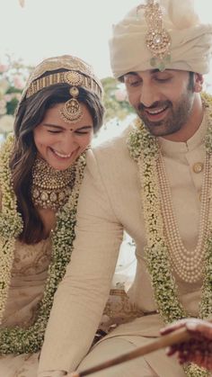 a bride and groom cutting their wedding cake