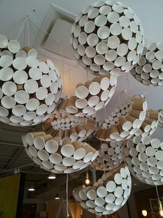 many white plates are hanging from the ceiling