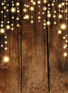 glowing stars hanging from strings on wooden background