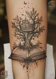 an open book with a tree on top of it and a house in the middle