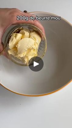 a person is scooping ice cream into a bowl on a white plate with gold trim