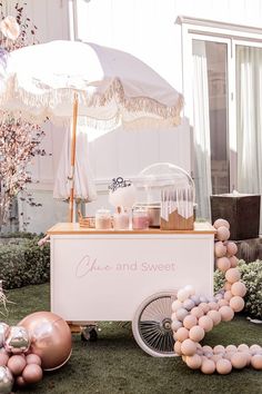 an ice cream cart decorated with balloons and decorations