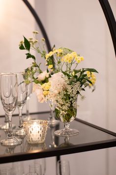 This image features a small floral arrangement on a champagne rack stand for a wedding cocktail hour. It is accented with a little votive candle and features white and yellow blooms accented with greenery. In an ayre bud vase. Wedding Reception Cocktail, Wedding Reception Cocktail Hour, Reception Cocktail, Gallery Photography, Photography Location, Location Photography, Votive Candle, Bud Vase, Cocktail Hour