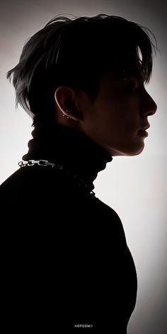 the silhouette of a woman with black hair and piercings on her neck is shown