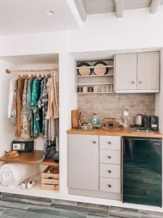 an open closet with clothes hanging on the wall