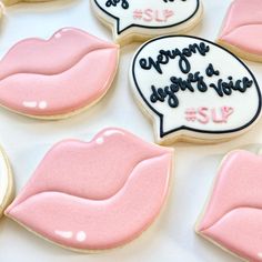 decorated cookies with pink and white frosting are arranged in the shape of kiss lips