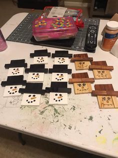 a table topped with lots of wooden blocks and some paint on it's surface