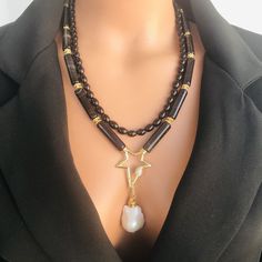 📍 Description :  The handmade multistrand necklace has been designed with Oyx gemstone in black colour and AAA+quality Baroque pearl You can choose this statement necklace for your mom, wife or girlfriend as a gift. 💎 Pendant : AAA+ quality Baroque Pearl 30 mm 💥 The colours of the stone may differ slightly in photo shoots caused by lighting and reflections. The necklace is Modern chunky statement gemstone beaded asymetrical necklace for women. The necklace does not stretch and well kept its s Unique Double Strand Beaded Necklaces, Unique Double Strand Beaded Necklace, Luxury Handmade Double Strand Necklace, Multi-strand Pearl Necklace With Natural Stones For Gifts, Multi-strand Jewelry With Pearl Pendant For Gift, Luxury Gemstone Beaded Necklace For Gift, Gift Multi-strand Pearl Necklace With Natural Stones, Handmade Double Strand Beaded Necklaces, Handmade Double Strand Beaded Necklace