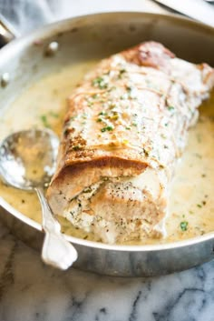 a piece of fish is in a pan with broth