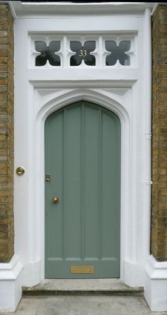 a green front door on a brick building