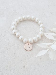 This sweet little pearl bracelet is personalised pearl to suit your bridal party. This bridal bracelet is made from 8mm glass pearls and 12mm rose gold plated initial disc. Your jewellery will arrive in a gift box ready for giving. This item ships from the UK within 1 working day. Please see size guide below: Sizes for children 3-6 months    4.25-4.5in 6-12 months    4.75in 12-24 months    5in 2-3 years    5.0-5.5in 4-5 years    5.75in 6-8 years    6in 9-13 years    6.25in Adult Sizes Small Adjustable Pearl Charm Bracelet For Bridesmaids, Adjustable Pearl Bracelet For Bridesmaids, Pearl White Bracelets With Pearl Charm For Bridesmaids, Adjustable Pearl Bracelets For Bridesmaids, Adjustable Beaded Bracelets With Pearl Drop For Bridesmaid, Adjustable Pearl Drop Bracelet For Bridesmaids, Pearl Charm Bracelet For Bridesmaid Gift, Pearl Charm Bracelet For Bridesmaids, Elegant White Name Bracelet For Bridesmaid Gift