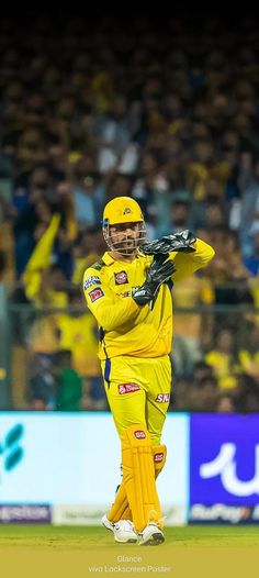 a man in yellow is playing cricket on the field