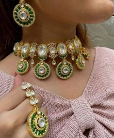 Stunning and gorgeous, silver foiled Kundan and High grade CZ stones studded very fine quality Sabyasachi emerald green necklaces with matching earrings and Maangtikka.  18 K gold plated rhodium plated  Earrings length: Approx 3 inches Earrings Closure: Pushback Necklace Closure: Adjustable Cord Maangtikka Is optional to purchase or not Highest quality and craftsmanship