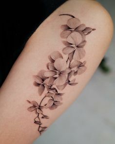 a tattoo with flowers on the arm