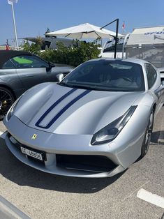 a silver sports car parked in a parking lot