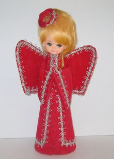 a doll with blonde hair and red dress